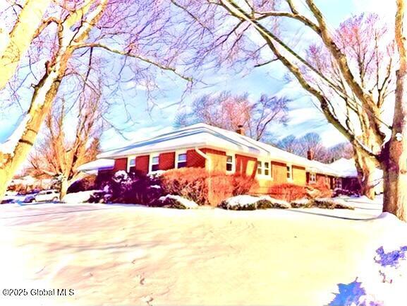 view of snow covered exterior with concrete driveway