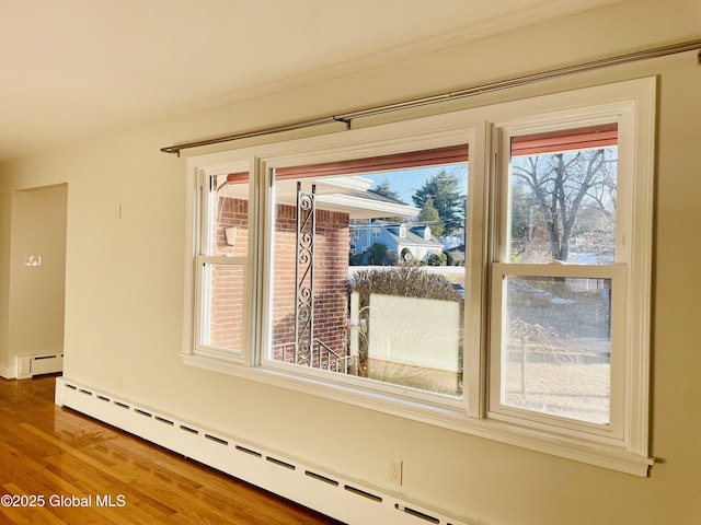 room details featuring baseboard heating and wood finished floors