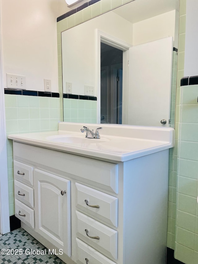 bathroom with vanity, tile walls, and a wainscoted wall