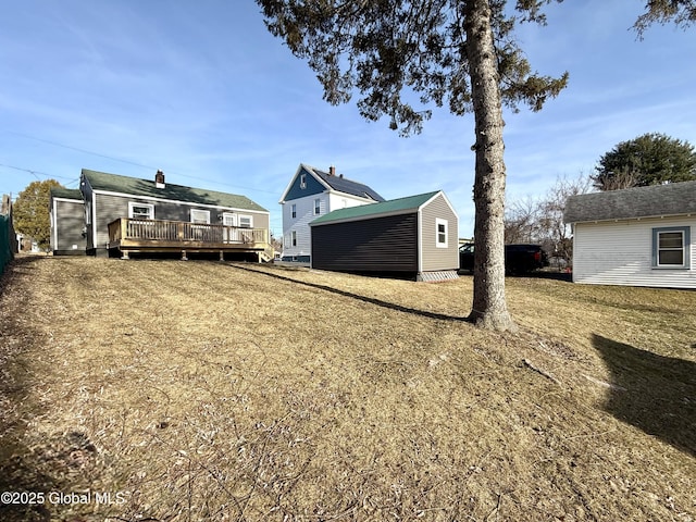 view of yard featuring a wooden deck and an outdoor structure