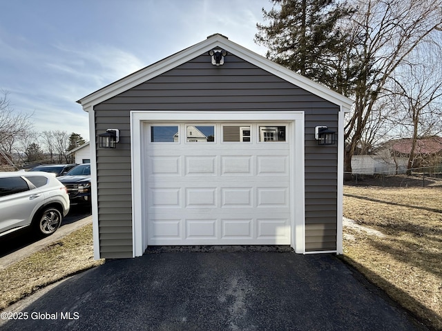 detached garage featuring aphalt driveway