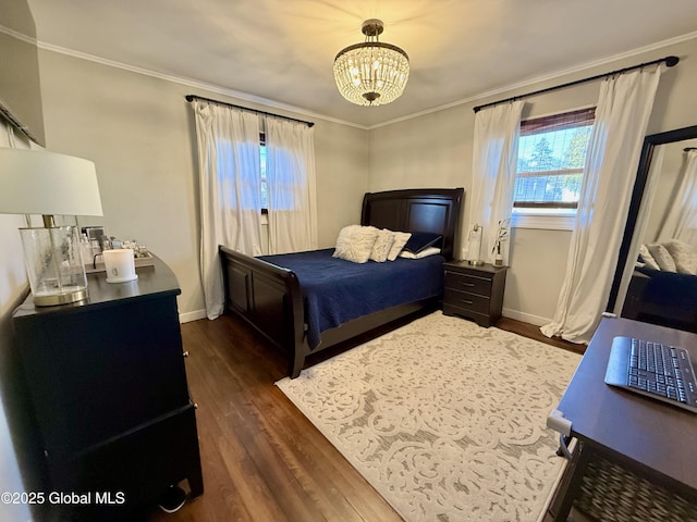 bedroom with an inviting chandelier, dark wood-type flooring, crown molding, and baseboards