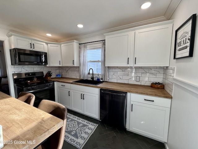 kitchen featuring a sink, wooden counters, black appliances, and crown molding