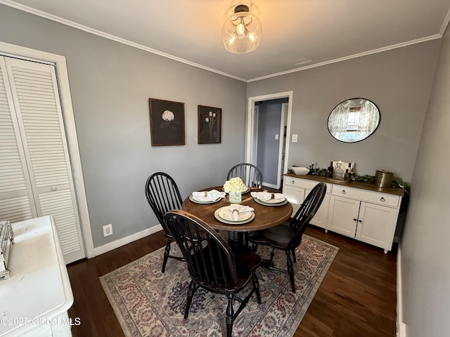 dining room featuring baseboards, ornamental molding, and dark wood-style flooring