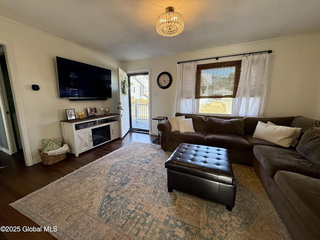 living area with a notable chandelier and dark wood-style flooring