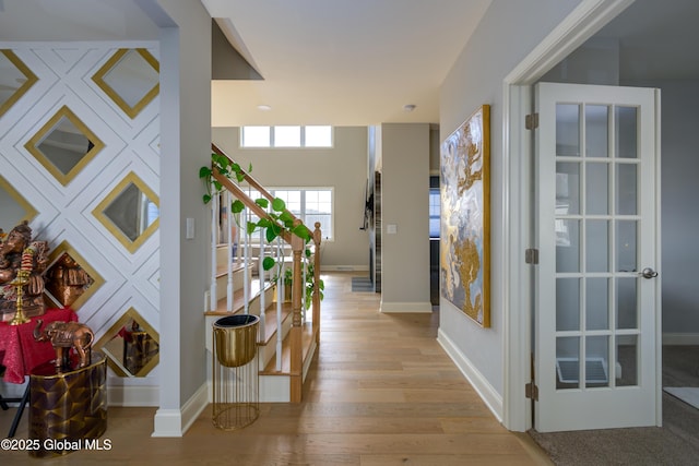 hall with light wood-type flooring and baseboards