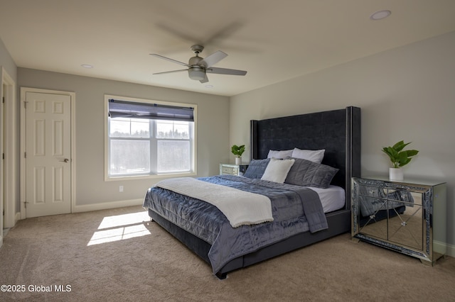 carpeted bedroom featuring a ceiling fan and baseboards