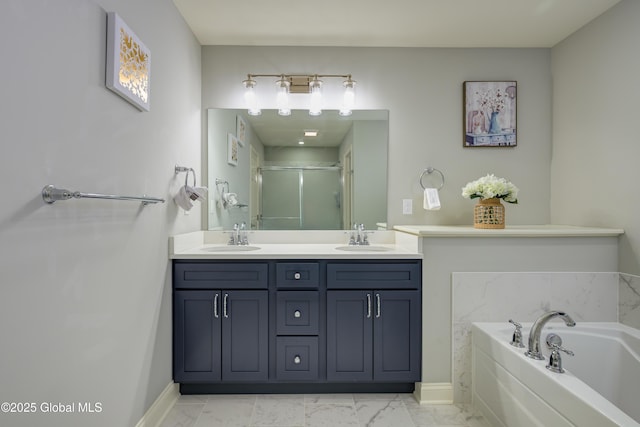 full bath with a sink, marble finish floor, and a shower stall