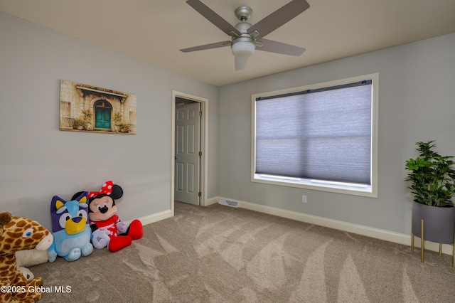 playroom featuring visible vents, baseboards, a ceiling fan, and carpet flooring