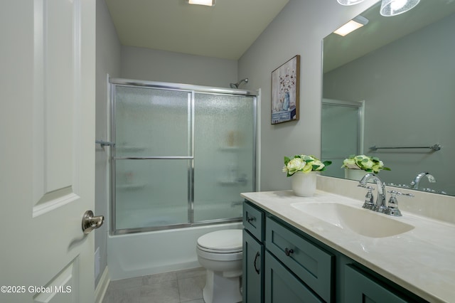 full bathroom with tile patterned floors, toilet, shower / bath combination with glass door, and vanity