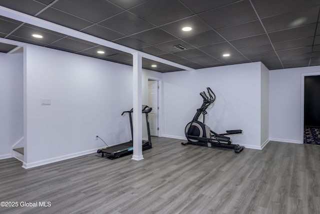 workout room with visible vents, baseboards, and wood finished floors