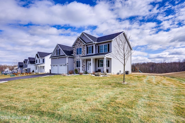 view of front of property with stone siding, driveway, and a front lawn