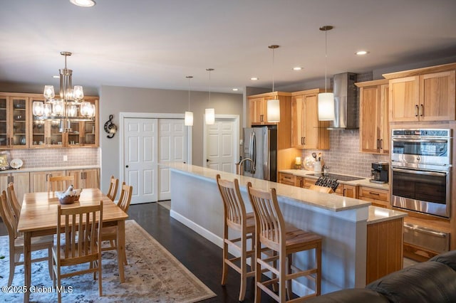 60 Federal Hill Rd, Bolton, NY 12814 - kitchen featuring wall chimney range hood, stainless steel appliances, a warming drawer, backsplash, and glass insert cabinets