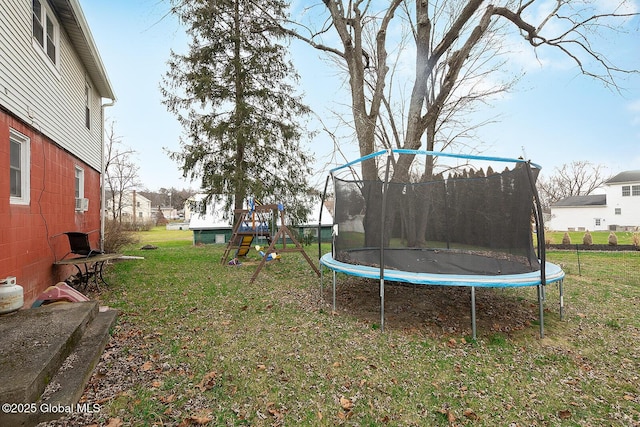 view of yard with a playground and a trampoline