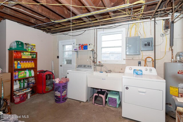 clothes washing area featuring water heater, laundry area, washing machine and dryer, and electric panel