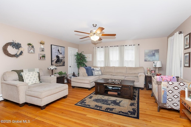 living area with light wood-style flooring and a ceiling fan
