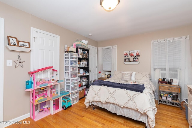 bedroom featuring cooling unit and wood finished floors