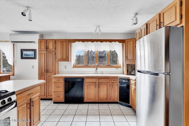 kitchen with an AC wall unit, a sink, freestanding refrigerator, light countertops, and dishwasher