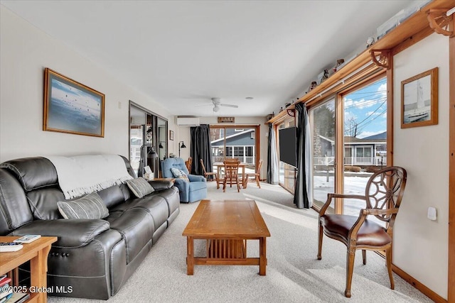 living room with a wall mounted air conditioner, a healthy amount of sunlight, ceiling fan, and carpet flooring
