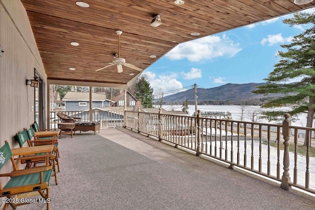 view of patio featuring a balcony, a mountain view, and ceiling fan