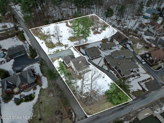 snowy aerial view with a residential view