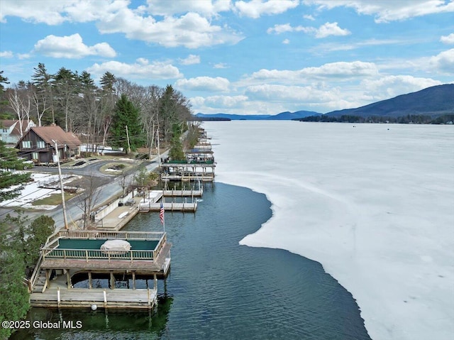 view of water feature with a floating dock and a mountain view
