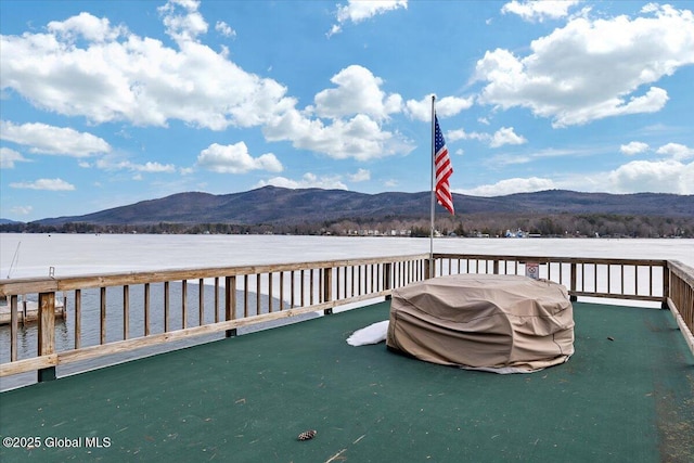 wooden terrace featuring a mountain view and a grill