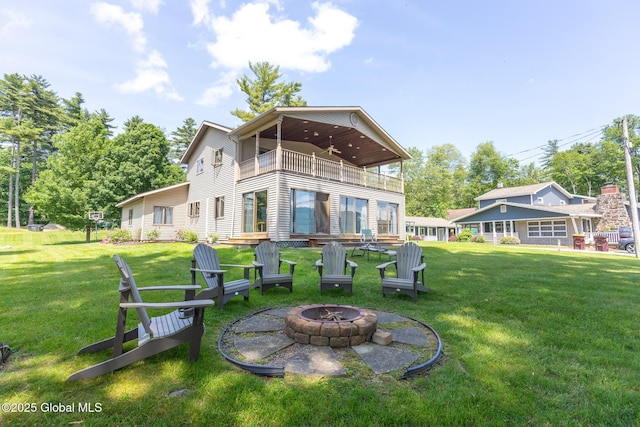 133 Assembly Point Rd, Queensbury, NY 12845 - rear view of house featuring a balcony, a fire pit, a yard, and a ceiling fan