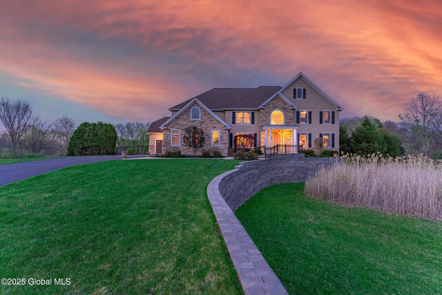 1014 Catherines Woods Dr, Niskayuna, NY 12309 - georgian-style home featuring curved driveway, stone siding, and a yard