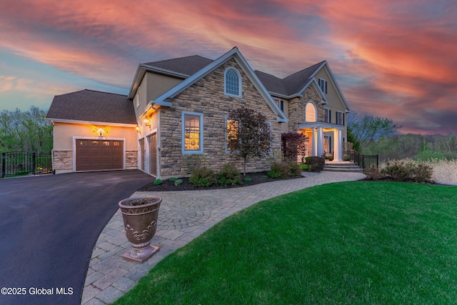 1014 Catherines Woods Dr, Niskayuna, NY 12309 - view of front facade featuring stone siding, stucco siding, driveway, and a garage