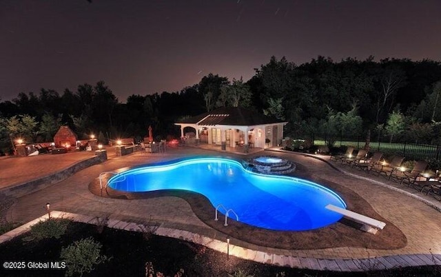 1014 Catherines Woods Dr, Niskayuna, NY 12309 - pool at night with a pergola, fence, an outdoor hot tub, a patio, and a diving board
