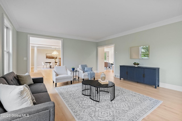 1014 Catherines Woods Dr, Niskayuna, NY 12309 - living area with a chandelier, ornamental molding, light wood-style flooring, decorative columns, and baseboards