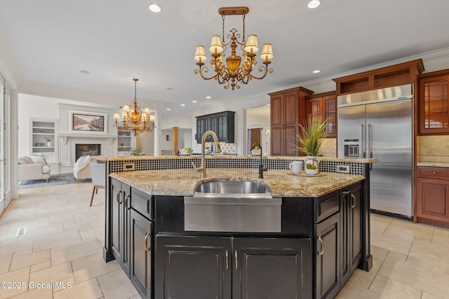 1014 Catherines Woods Dr, Niskayuna, NY 12309 - kitchen with built in refrigerator, a chandelier, a sink, tasteful backsplash, and dark cabinetry