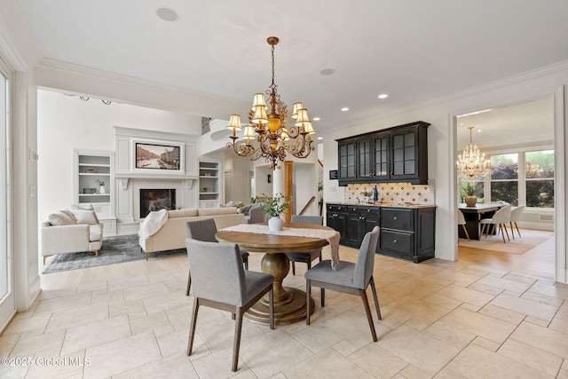 1014 Catherines Woods Dr, Niskayuna, NY 12309 - dining room featuring a chandelier, crown molding, built in features, recessed lighting, and a premium fireplace