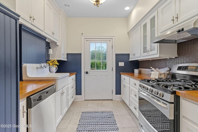 1014 Catherines Woods Dr, Niskayuna, NY 12309 - kitchen with stainless steel appliances, butcher block counters, under cabinet range hood, white cabinets, and wainscoting