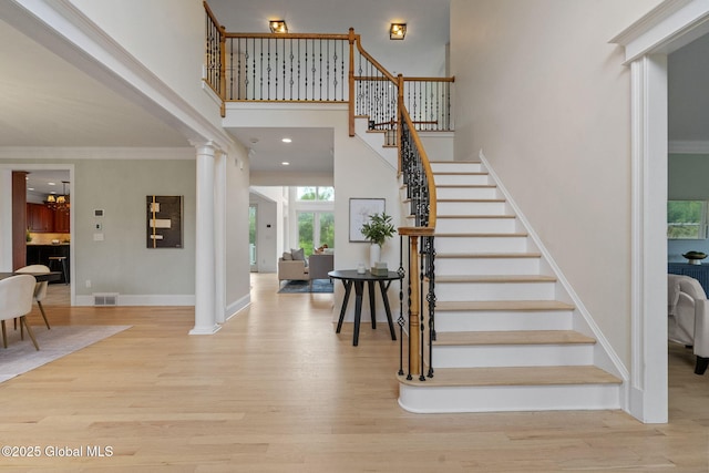 1014 Catherines Woods Dr, Niskayuna, NY 12309 - foyer with stairway, ornate columns, wood finished floors, a high ceiling, and crown molding