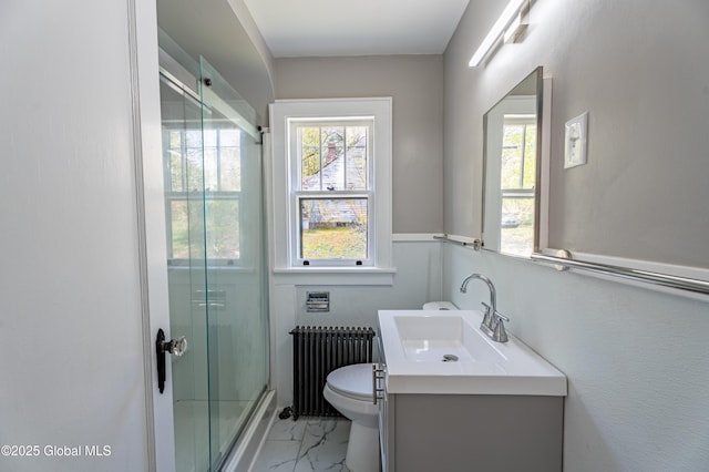 bathroom featuring vanity, a shower with door, marble finish floor, toilet, and radiator heating unit