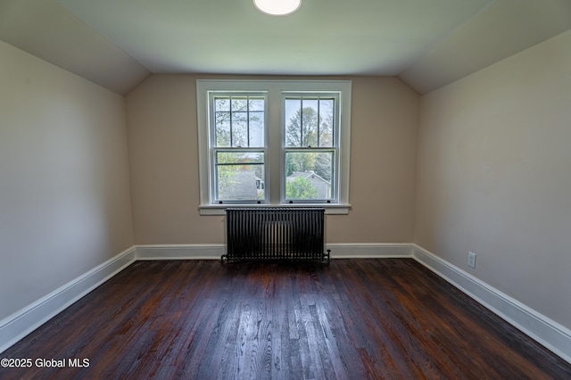bonus room featuring baseboards, lofted ceiling, dark wood finished floors, and radiator