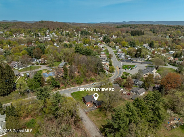 aerial view featuring a view of trees and a mountain view