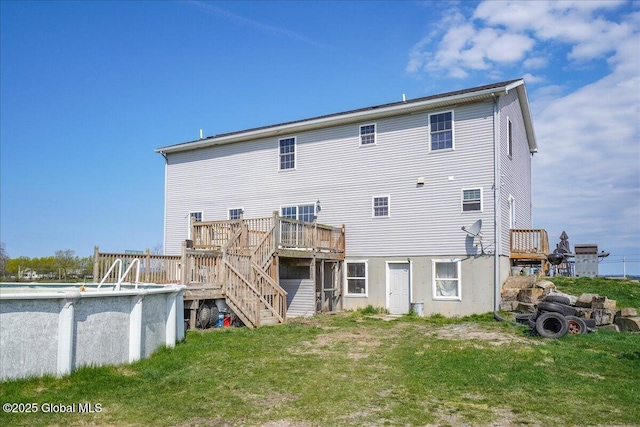 346 State Route 197, Fort Edward, NY 12828 - back of property featuring stairway, a wooden deck, an outdoor pool, and a lawn