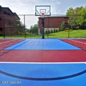view of sport court featuring basketball court and fence