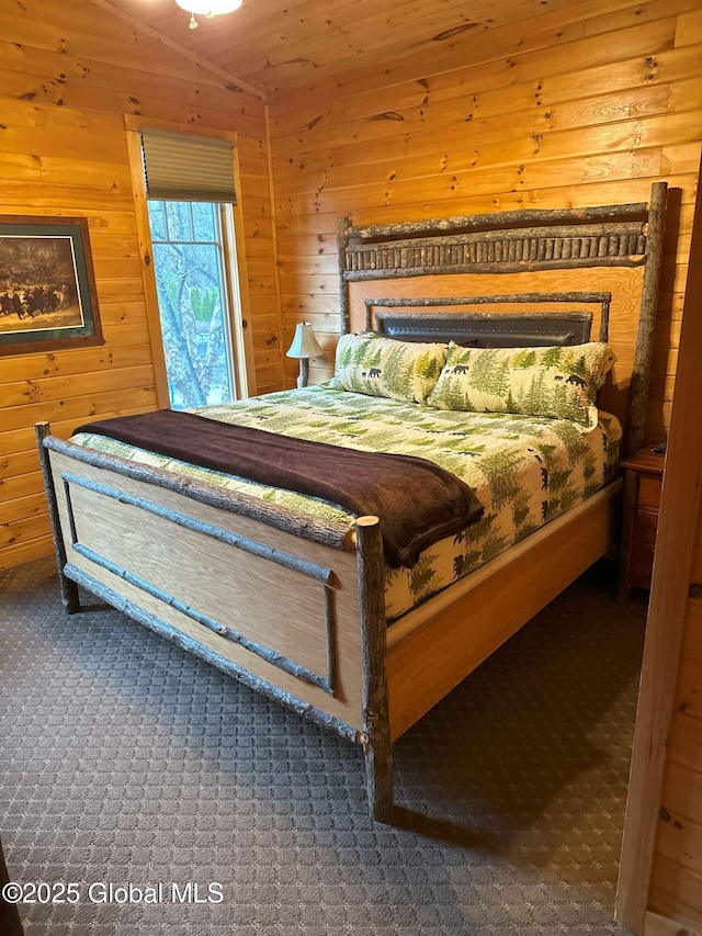 bedroom featuring wood walls and carpet floors