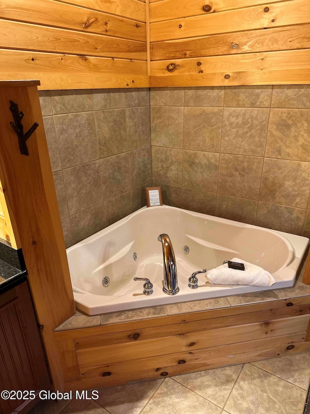 bathroom with tile patterned floors and a jetted tub