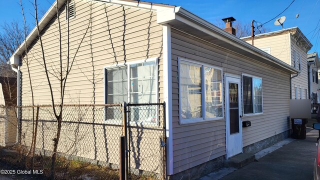 9 Penrose Ave, Mechanicville, NY 12118 - view of side of home with fence and a chimney