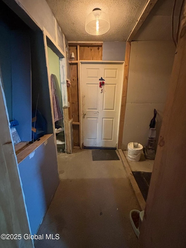 mudroom with a textured ceiling