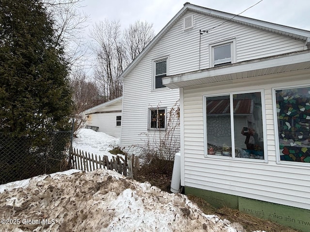 view of side of home featuring fence
