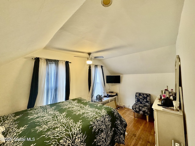 bedroom with lofted ceiling, hardwood / wood-style flooring, and ceiling fan