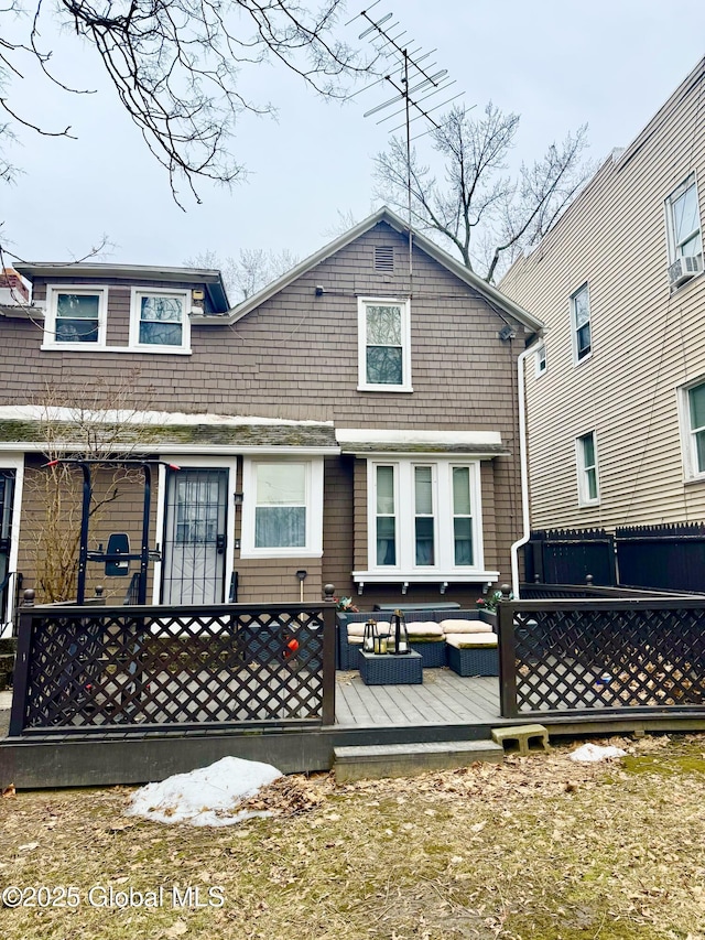 back of house featuring a wooden deck