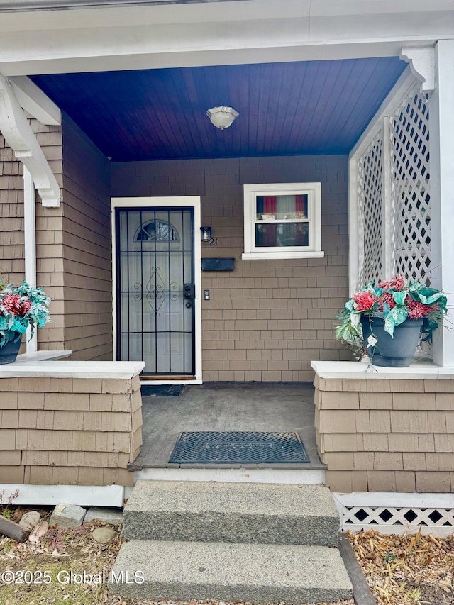 view of exterior entry with covered porch