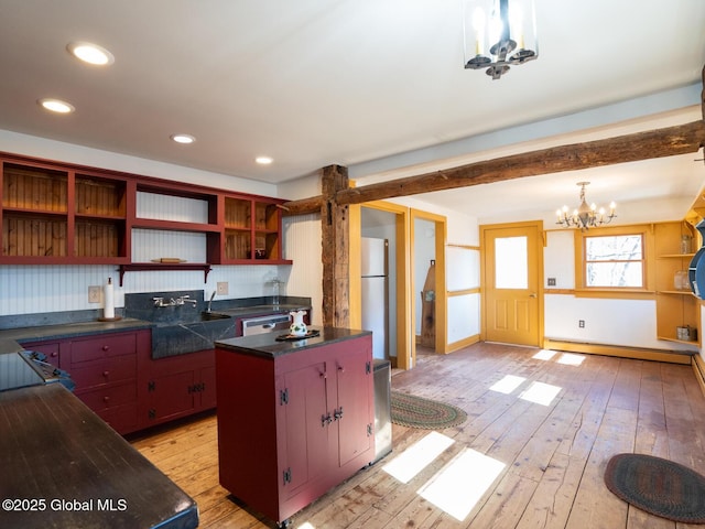 kitchen featuring a chandelier, open shelves, a baseboard heating unit, dark countertops, and light wood-type flooring